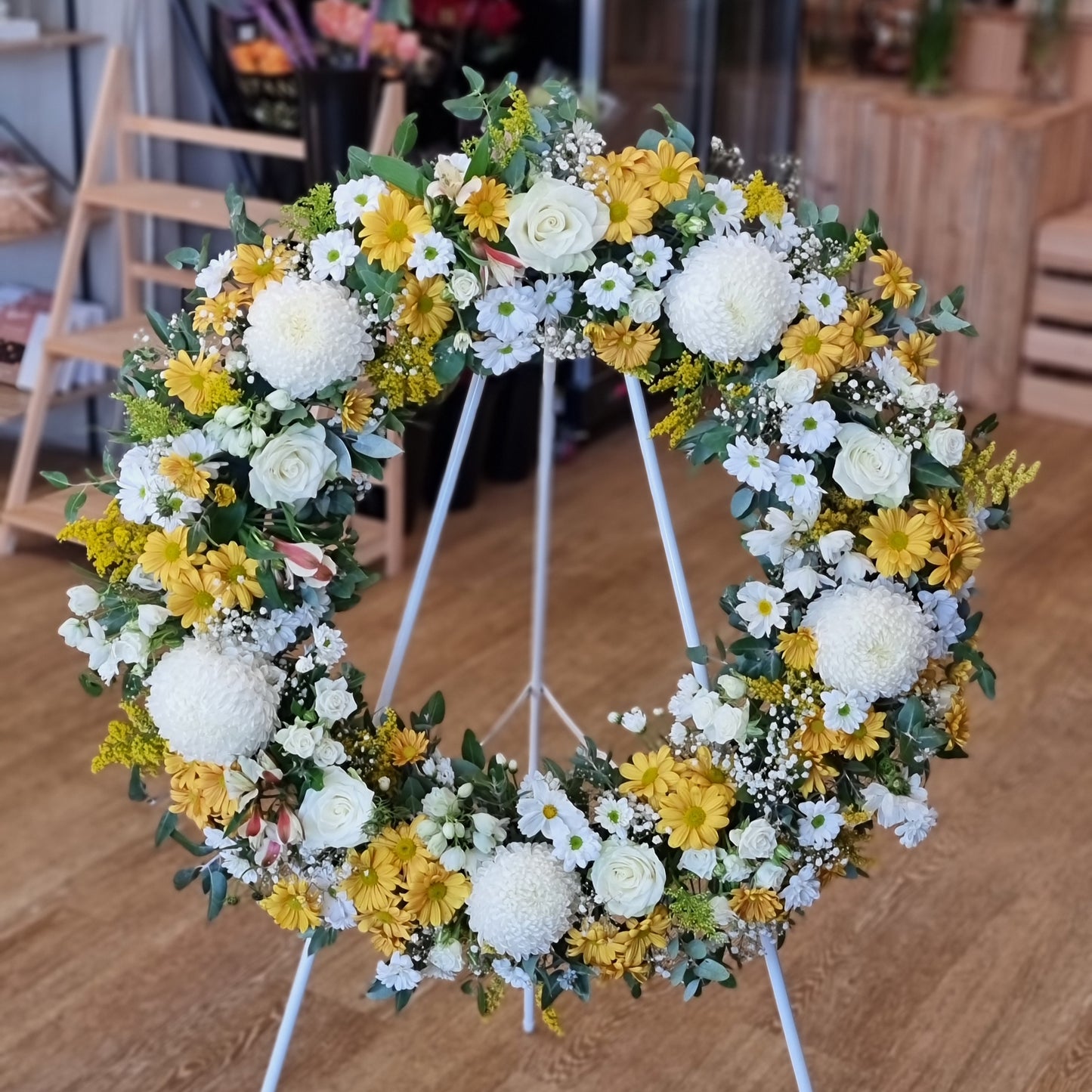 Classic white and yellow sympathy wreath for funerals and memorials | Serene and uplifting floral tribute | Flowerland Nunawading