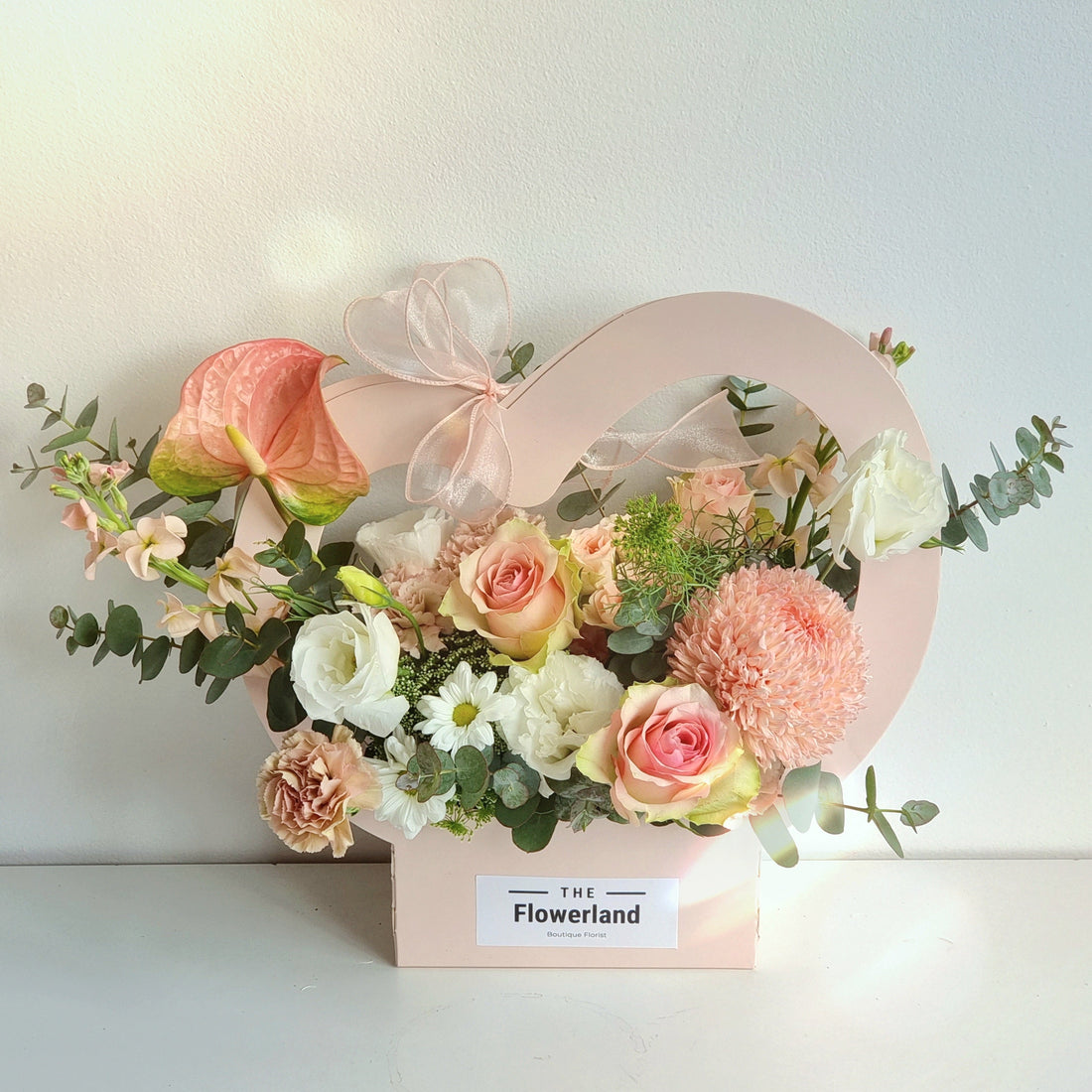 "Same-day flower delivery in Melbourne's East: An elegant arrangement of pink roses, white chrysanthemums, and peach anthuriums, showcasing the artisanal quality delivered to local residential streets."