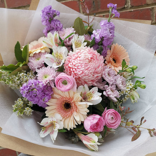 Professional florist bouquet with pink gerberas and purple irises for same-day delivery to Melbourne suburbs.