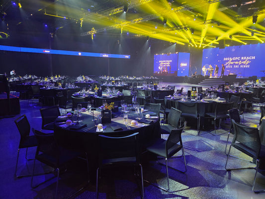 Professional floral styling for a corporate 50th Anniversary Gala at a Southbank, Melbourne event venue. Showcasing bespoke gold and yellow floral centerpieces designed by Flowerland for large-scale corporate event planning.