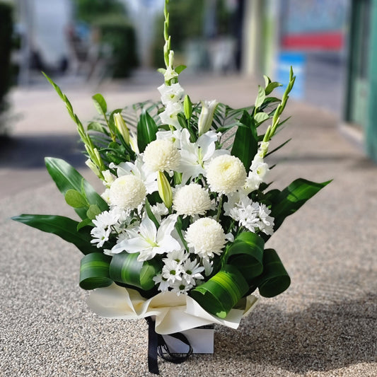 Elegant white floral arrangement in Camberwell by The Flowerland - professional same-day delivery for local events and residences.