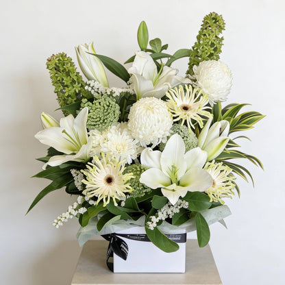 Hand-prepared white lily and green foliage bouquet for same-day delivery to Heathmont. Captured near Heathmont Station to document 3135 local logistics with f/1.8 clarity, showcasing The Flowerland's craftsmanship.
