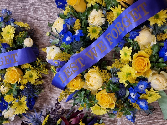 Bright yellow and blue ANZAC Day wreath with Australian native flowers and Lest We Forget ribbon | Memorial tribute | Flowerland Nunawading