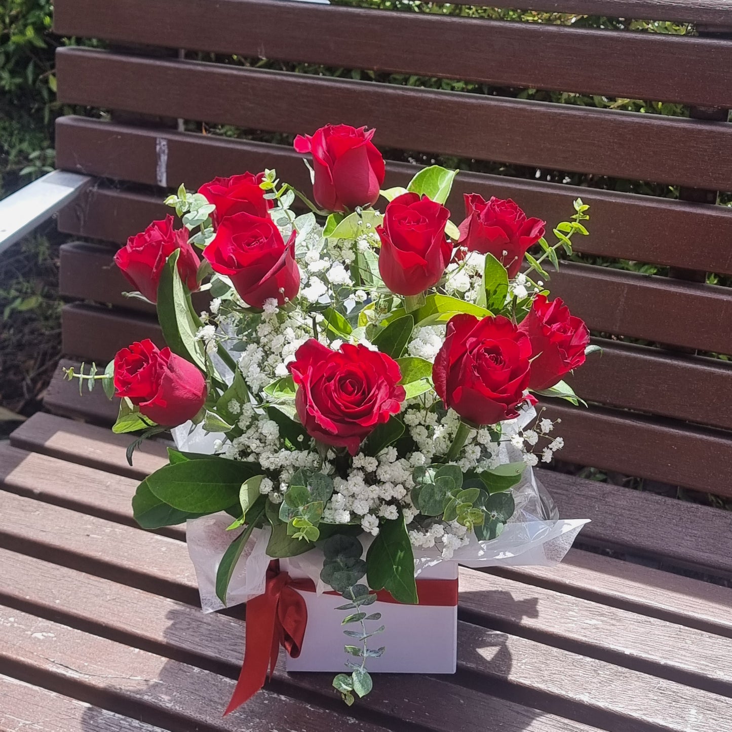 Elegant Rose Box arrangement featuring 10 premium red roses with fresh seasonal foliage and white gyp same-day delivery The Flowerland Nunawading
