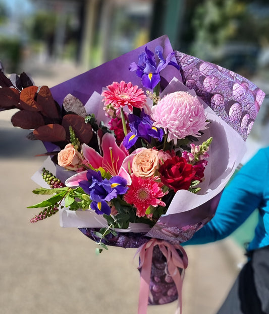 Handcrafted Mother's Day bouquet featuring vibrant pink, red, and purple flowers, wrapped for premium delivery to a retirement village resident in Doncaster East or Templestowe.