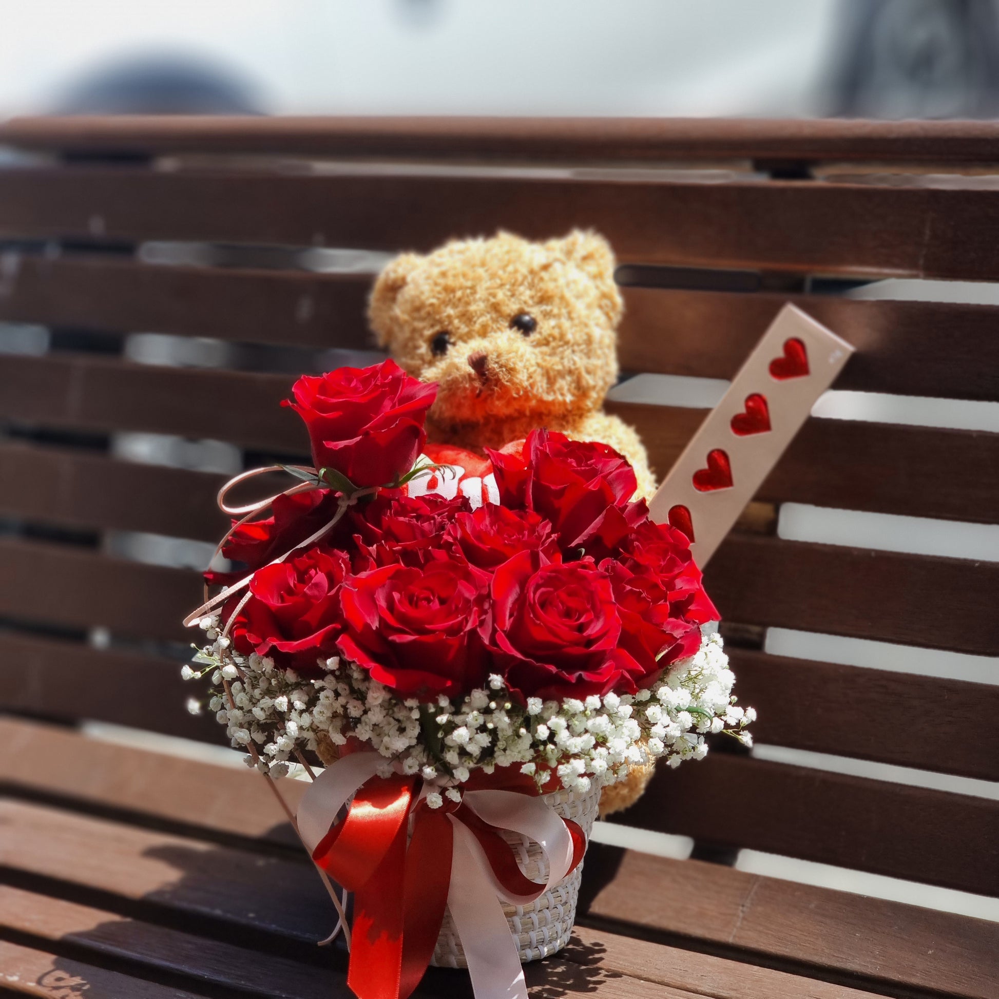 Top down view of a romantic red rose and chocolate gift basket delivered via temperature controlled couriers to premium apartments in Glen Waverley.