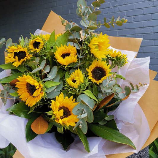 Bright golden sunflowers with fresh eucalyptus foliage bouquet for reliable same-day delivery to classic homes in Balwyn.
