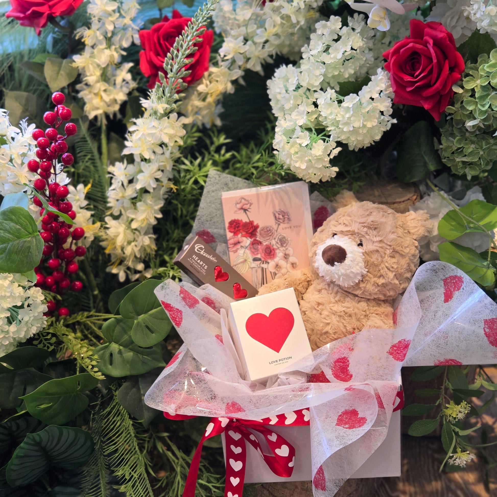 Sweet romantic gift hamper with a teddy bear, Pinkmint love potion candle, Chocolatier chocolates and greeting card in love heart gift box | Flowerland Nunawading 