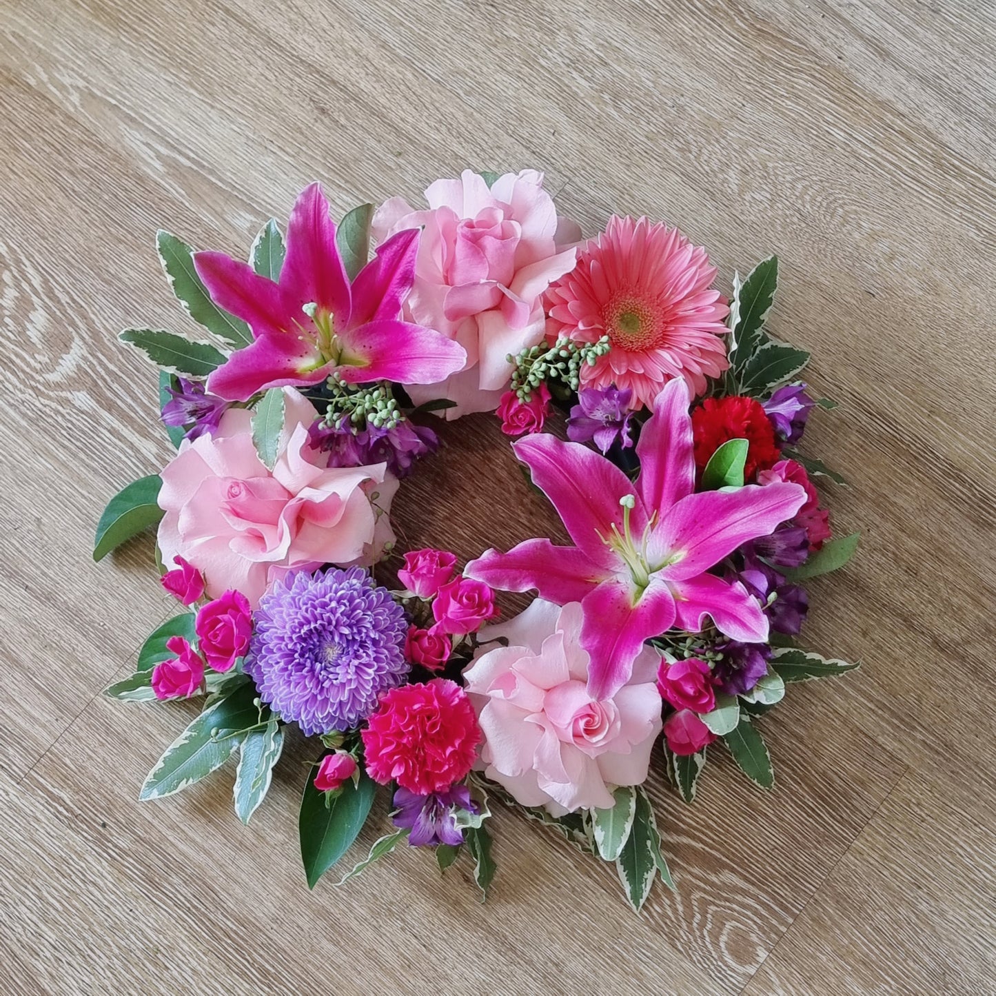 Bright and beautiful sympathy wreath in soft pink and purple tones for funerals and memorials | Heartfelt floral tribute | Flowerland Nunawading