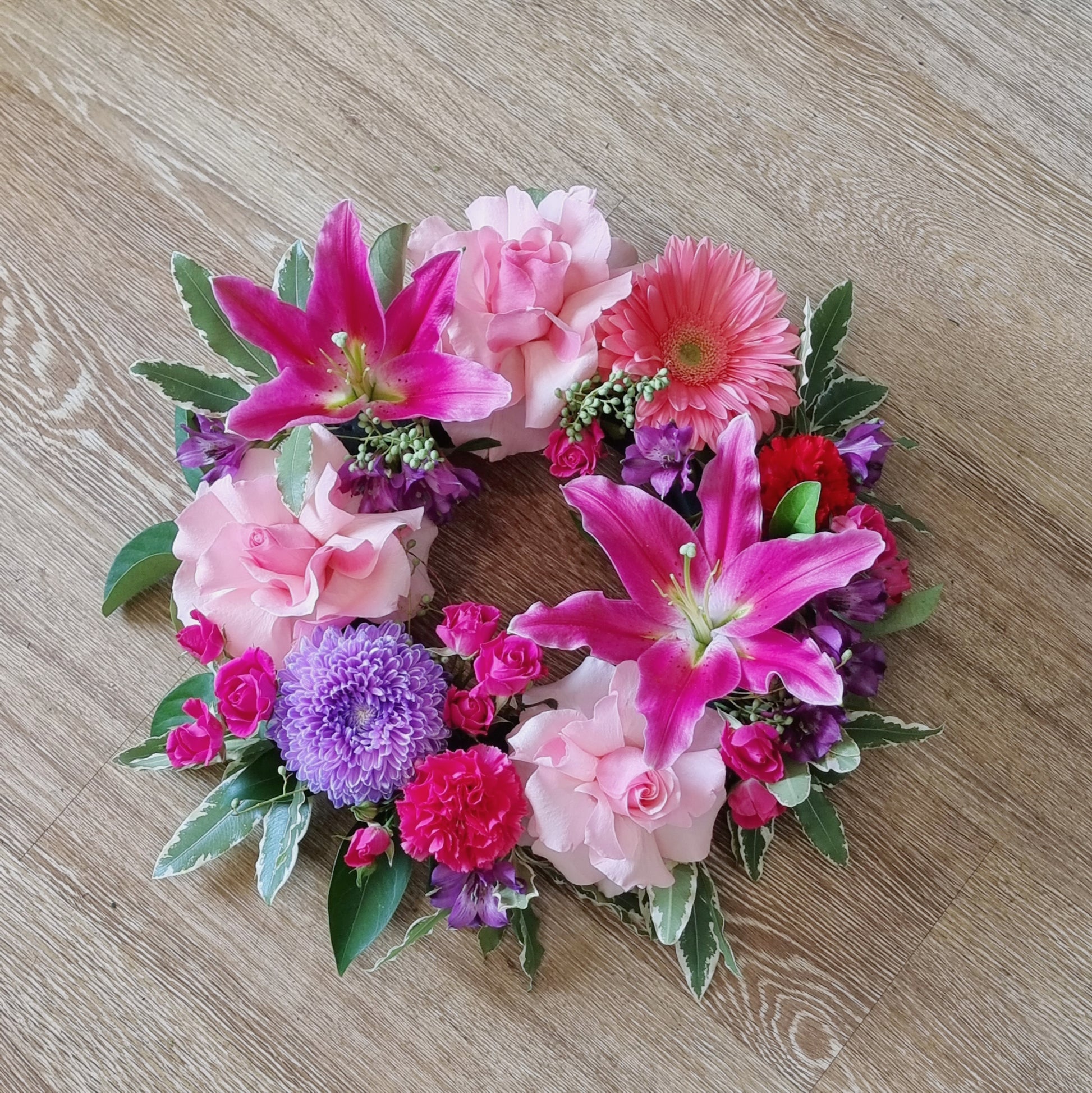 Bright and beautiful sympathy wreath in soft pink and purple tones for funerals and memorials | Heartfelt floral tribute | Flowerland Nunawading