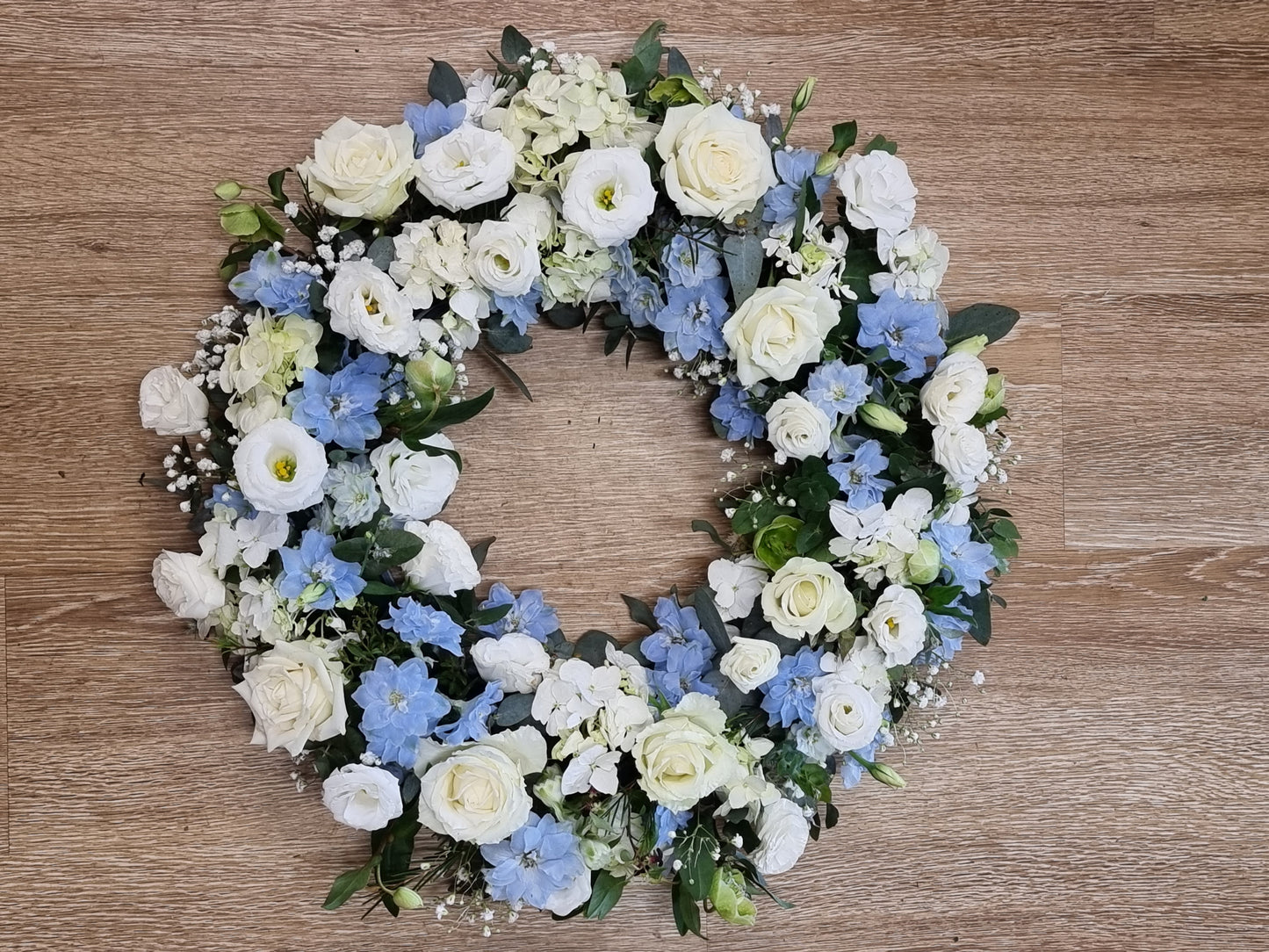 Serene white and blue sympathy wreath for funerals and memorials | Peaceful floral tribute with fresh flowers | Flowerland Nunawading