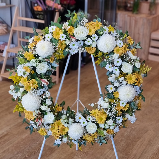 Classic white and yellow sympathy wreath for funerals and memorials | Serene and uplifting floral tribute | Flowerland Nunawading