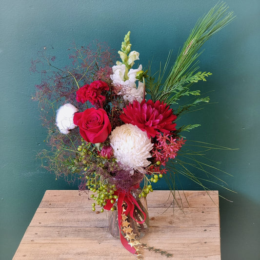 Gorgeous Xmas Vase arrangement featuring festive red roses, white blossoms, and holiday greenery fillers same-day delivery The Flowerland Nunawading