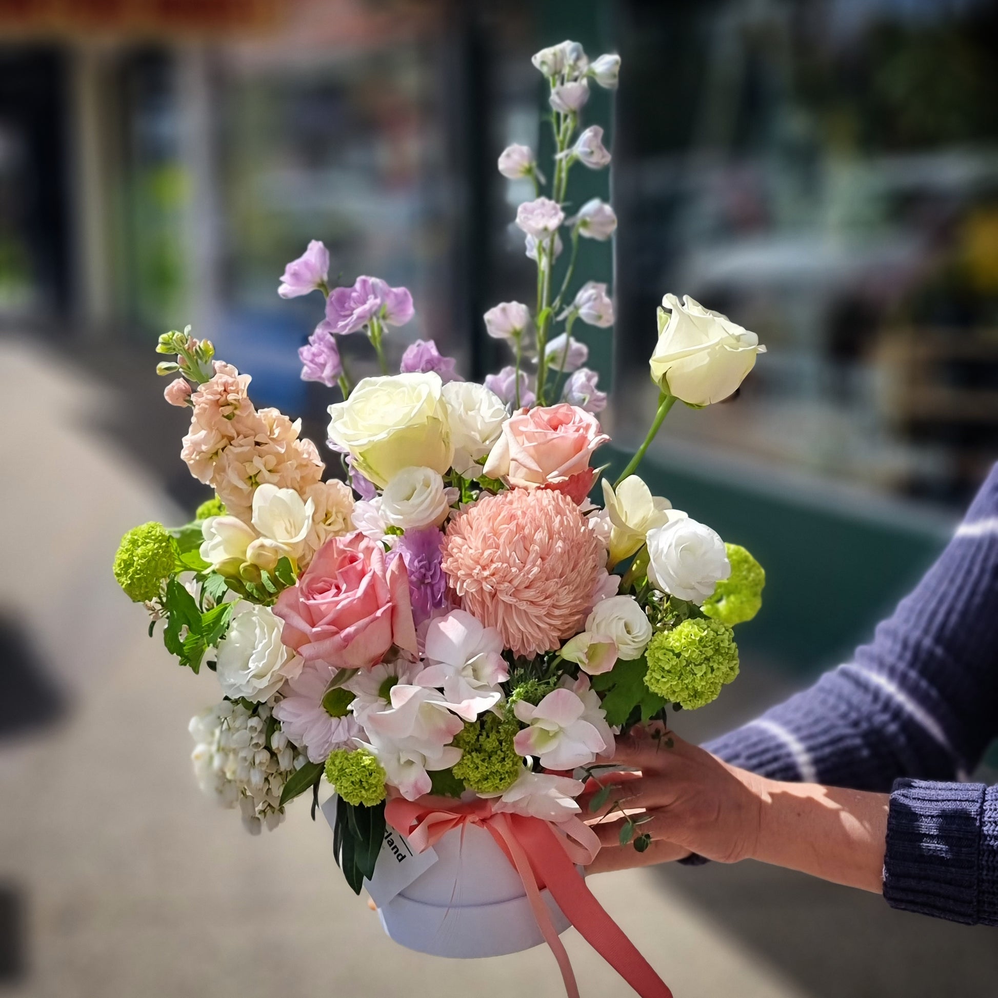Bespoke luxury hatbox flower arrangement with tall purple delphinium and soft pastel hydrangeas same-day delivery Flowerland Nunawading