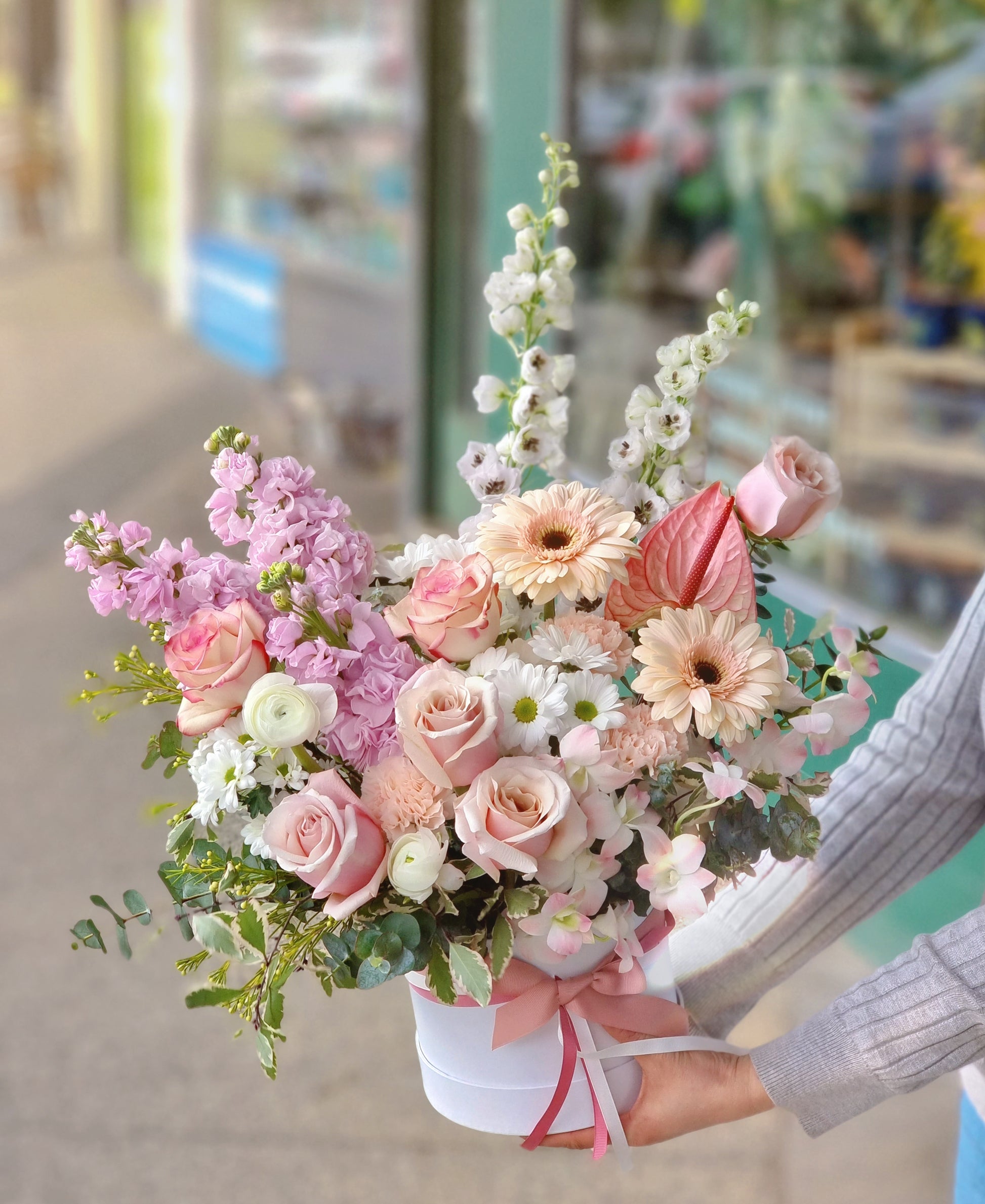 Bespoke soft pink and purple themed hatbox featuring large disbud chrysanthemums by local florist near Balwyn.