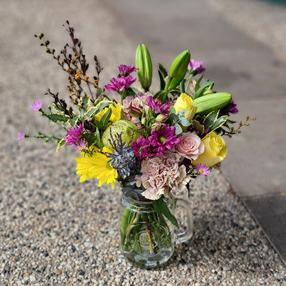 Fresh mixed seasonal flower posy arrangement in a rustic glass jar same-day delivery The Flowerland Nunawading