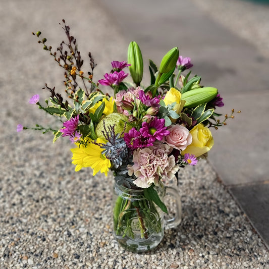 Fresh mixed seasonal flower posy arrangement in a rustic glass jar same-day delivery The Flowerland Nunawading
