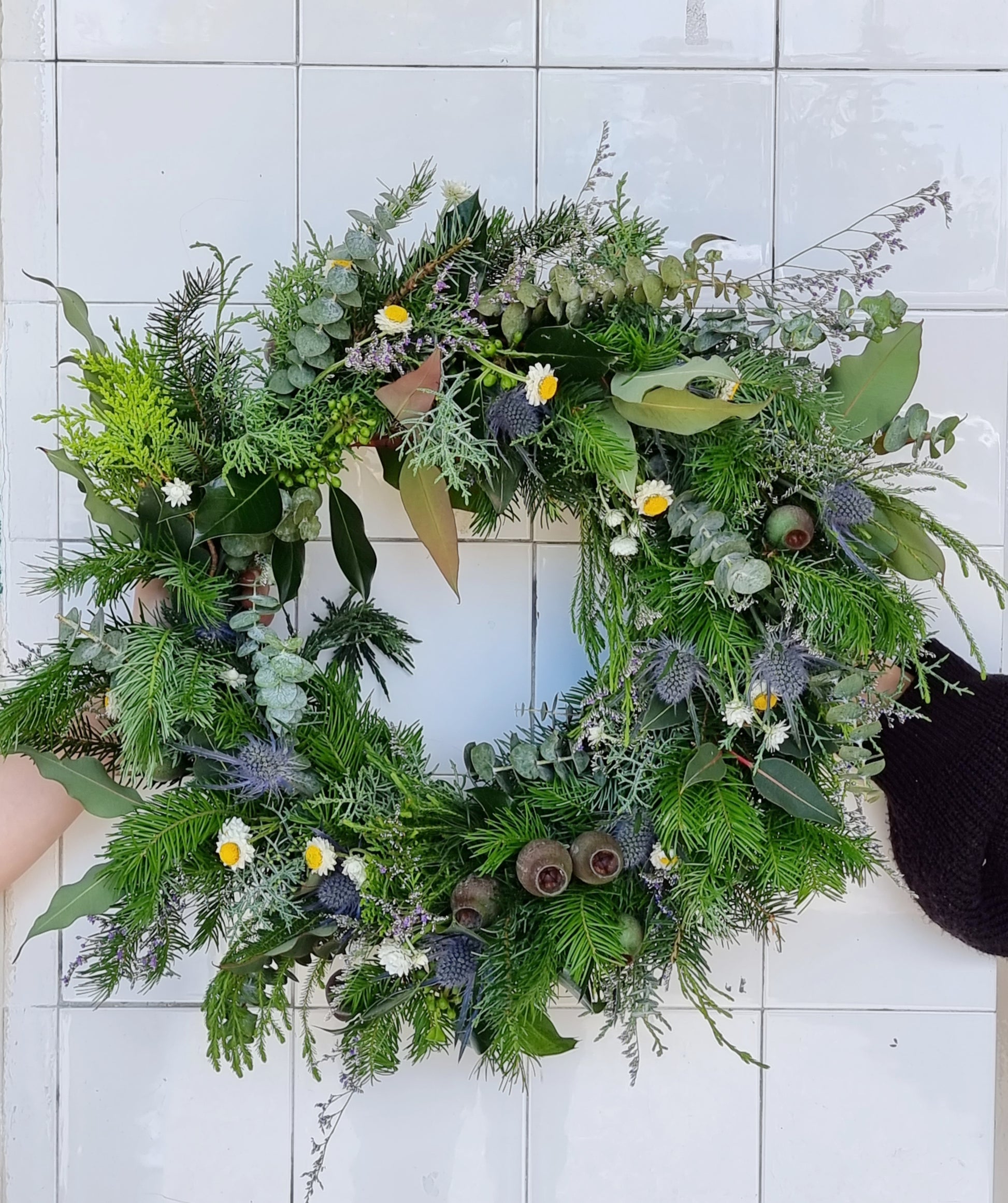 Festive fresh to dry Christmas door wreath featuring textured seasonal evergreens and holiday foliage same-day delivery The Flowerland Nunawading