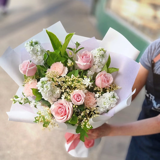 Charming graduation bouquet pink with premium blush roses and fresh white seasonal fillers wrapped for celebration The Flowerland Nunawading