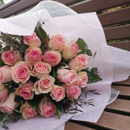Elegant premium pink roses bouquet resting on a wooden bench prepared for same-day floral delivery across Box Hill.