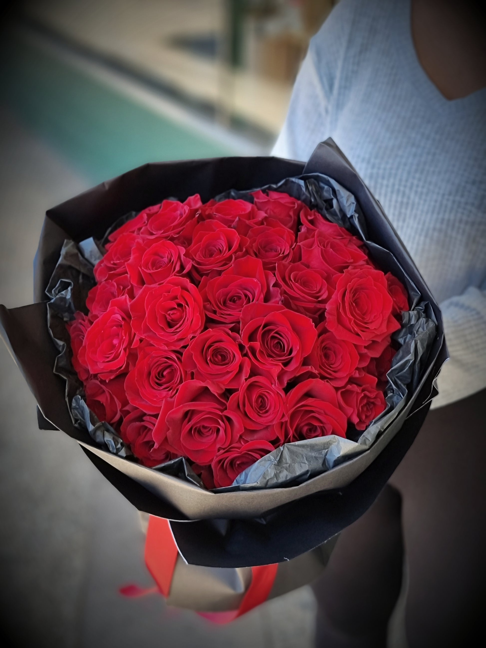Close up detail of luxury red roses nested in elegant mesh wrapping paper available near Knox.