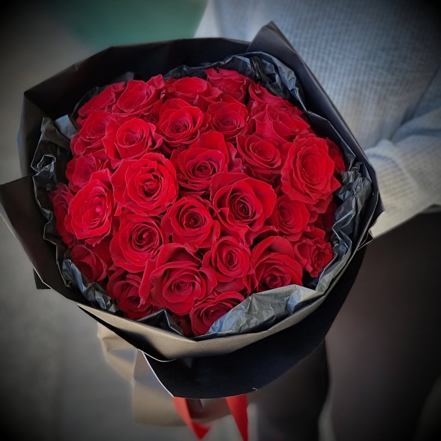 Classic romantic Roses Only bouquet featuring premium red roses wrapped in luxury dark paper same-day delivery The Flowerland Nunawading