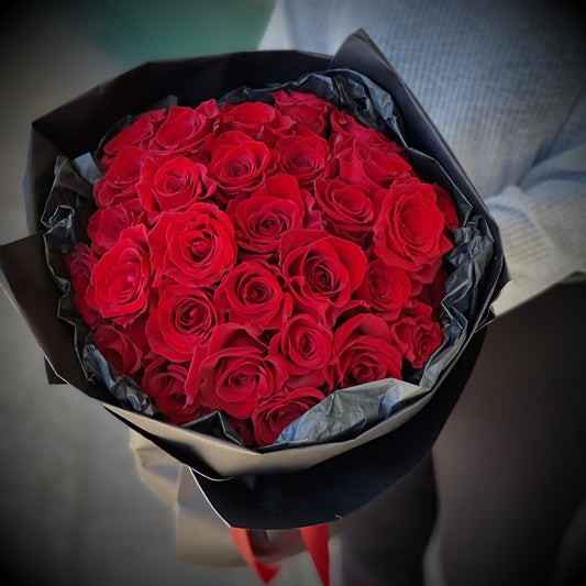 Classic romantic Roses Only bouquet featuring premium red roses wrapped in luxury dark paper same-day delivery The Flowerland Nunawading