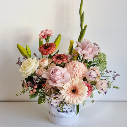 Luxury bespoke hatbox arranged with fresh white lilies and blush pink roses delivered straight to Surrey Hills homes.