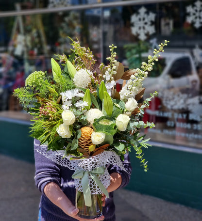 Elegant white vase flower arrangement featuring premium market white roses, lilies, and texturized native foliage same-day delivery Flowerland Nunawading