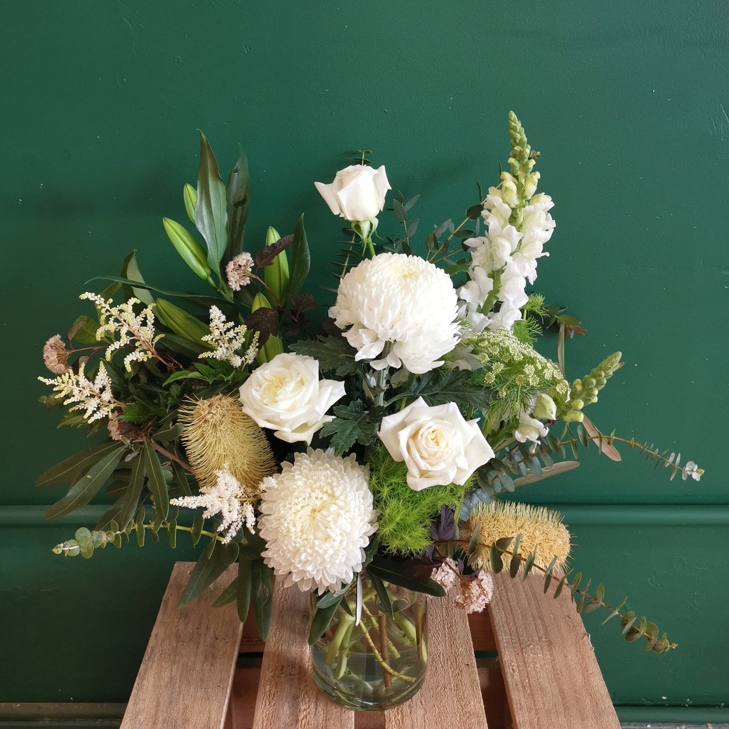 Sophisticated pure white flower arrangement with fresh snapdragons and eucalyptus in a classic glass vase delivered straight to Balwyn.